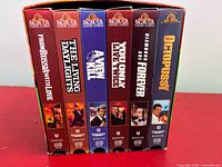 Front view of six VHS tapes in slipcase showing titles
