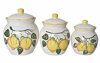 Front view of three graduated lemon motif canisters with lids
