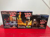 Front view of all three An Evening of Murder boxed games