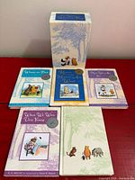 Front view of five books and slipcase showing cover art and medal stickers