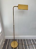 Full view of brass-tone pharmacy floor lamp showing base, pole and shade