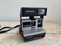 Front view of Polaroid Sun 600 LMS camera showing flash and lens area