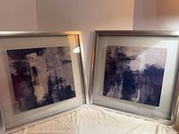 Both framed abstract artworks side by side