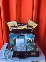 Briefcase open showing packaged scarves, durags and crocheted hair nets
