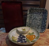 Overview shot of chip and dip bowl, red tray, speckled pan