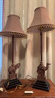 Both figural lamps with shades shown side by side