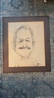 Full view of framed pencil caricature portrait
