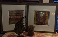 Both framed prints with candle holder and tabletop decor