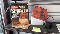 Sprayer, adapter, box and manual on shelf