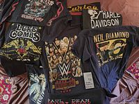 Overview of several T-shirts showing front graphics and logos
