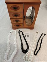 Group shot showing jewelry box and four necklaces