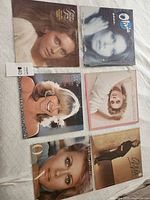 All six Olivia Newton-John LP albums arranged on surface