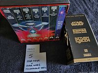 Closed Star Trek six-film slipcase beside Star Wars Trilogy gold slipcase