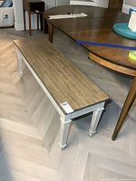 overall view of wooden bench with brown seat and white base