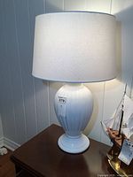 Lamp on wooden table showing full lamp with shade