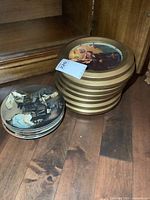 Stack of framed plates next to stack of loose plates