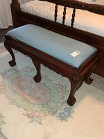 Full view of bench beside bed