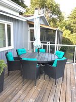 Full patio set showing table, six chairs, umbrella