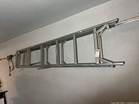 Full view of aluminum ladder mounted horizontally; shows overall length and structure