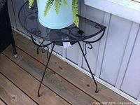 Full view of demilune glass-top table on deck