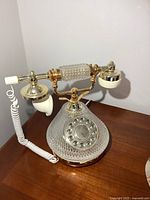 Full view of telephone showing glass-style base, handset, cord