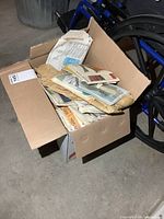 Closed cardboard box full of sewing pattern envelopes