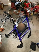 Full view of blue Drive rollator walker showing seat, backrest, wheels, and hand brakes