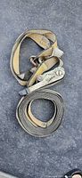 Two coiled yellow ratchet straps showing ratchet mechanism and hooks