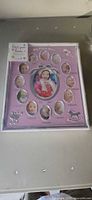 Front view of packaged baby first year photo frame showing design and size