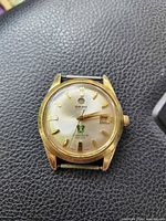 Front view showing dial, indices, date window, Green Horse emblem