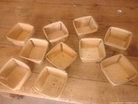 Top view of nine square wooden berry baskets on a table