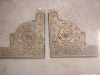 Front view of both matching ornate bronze cash register side panels