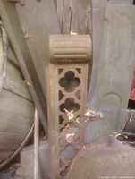 Front view of cast iron bracket showing quatrefoil openings and ribbed top