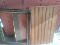 Cutting board and picture frame leaning against wall