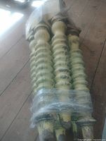 Bundle of four spiral-turned wooden legs with green paint and square top blocks