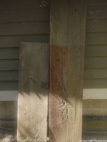 Two antique pine boards leaning against wall showing relative sizes