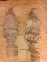 Front view of both carved oak finials showing shape and decorative carving