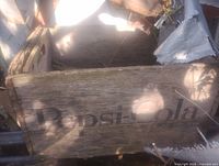 Side view of wooden Pepsi-Cola crate displaying logo