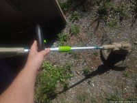 Full view of electric string trimmer held by hand