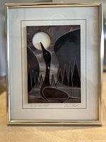 Frontal view of framed carved glass artwork