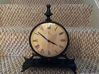 Front view of table clock on stairs