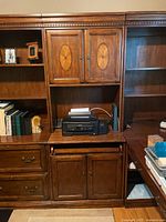 Front view showing cabinet, drawers, pull-out shelf, upper doors with inlay
