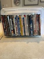 Clear plastic bin holding upright DVD and Blu-ray cases