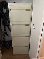 Full view of beige 4-drawer metal filing cabinet