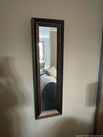 Front view of rectangular mirror on wall showing full frame and glass