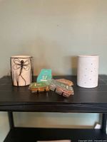 Both wax warmers and four sealed wax melt packs on shelving