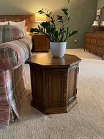 Full view of hexagon wooden side table next to sofa