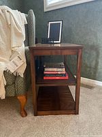 Side table front view showing middle shelf and books for scale