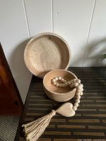 Two of the wood bowls displayed with bead garland