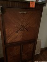 Front view of closed cabinet showing marquetry and overall design